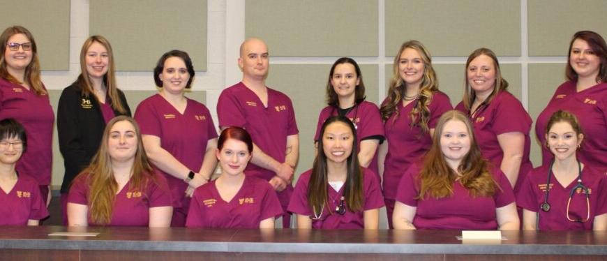 14 vet tech students in scrubs